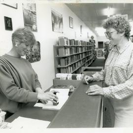 Checking out a book from the Coffs Harbour Library, 31 August 1988