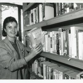 Woolgoolga Library assistant Janine shelving books, 15 August 1988