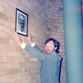 Derek Firman with his father's portrait in the Council Chamber