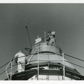 Fixing the weather vane on top of the Smoky Cape Lighthouse, 1977 