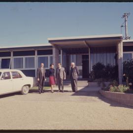 Group of people in front of building, c. 1966