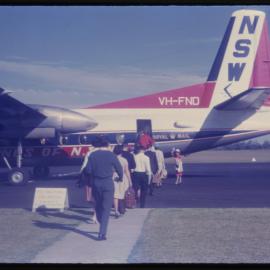 Passengers boarding airplane, Coffs Harbour Airport, c. 1962