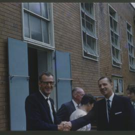 Two Rotarians shake hands, Coffs Harbour Public School, c. 1960s