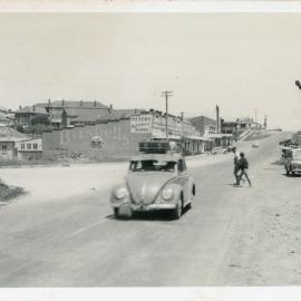 A Volkswagon motors down High Street at the Jetty village, 1950s