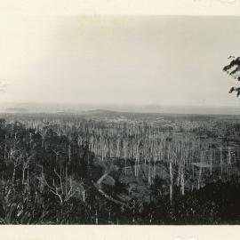 A road snakes down to the township, c. 1930
