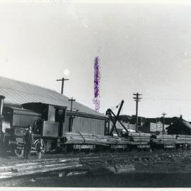 A train transfers timber between the goods shed and the Jetty
