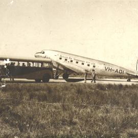 Butler Air Transport's DC3 Royal Mail plane "Warrina" is met by a town bus.