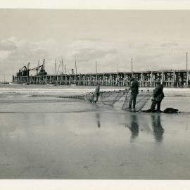 Netting fish on Park Beach in Sunday best, early 1930s
