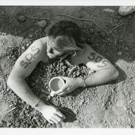 Protester buried to stop heavy machinery at the Look-At-Me-Now outfall protest, November 1991