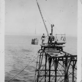 Winching up the basket of supplies at South Solitary Island jetty, early 1950s