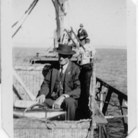 A passenger in the landing basket on the South Solitary Island jetty, 1951