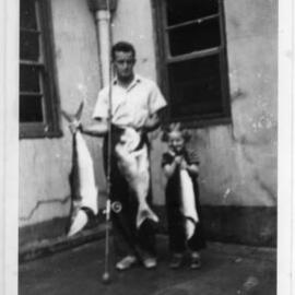 Lightkeeper Kevern Hobman and daughter Shirley with fish, 1952