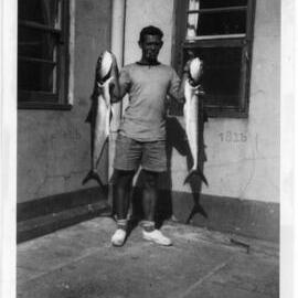 Lightkeeper Wally Chappelow with fish, 1952
