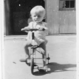 Steven Hobman riding his tricycle on South Solitary Island, 1954