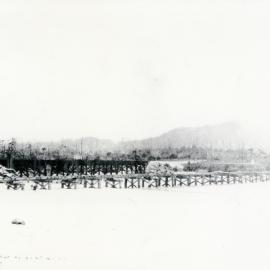 Pedestrian bridge and railway bridge across Coffs Creek, 1920s