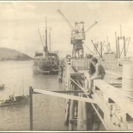 Loading timber onto the Kopua moored at the jetty, c.1955