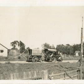 Steam tractor pulling a wagon along Lyons Road, c.1940