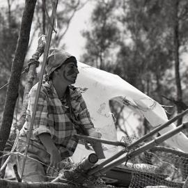 A protestor perches on top of a teepee, 25 November 1991