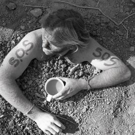 A protestor is buried up to his neck, late 1991