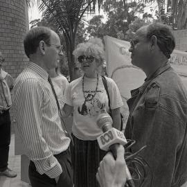Alph Williams is interviewed by journalists outside the City Council's Administration building, late 1991