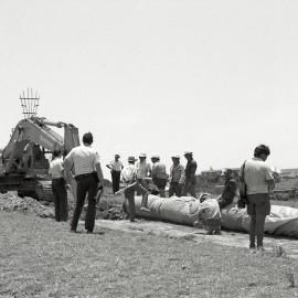 Police protect the trench digger and sewerage pipe, 3 December 1991