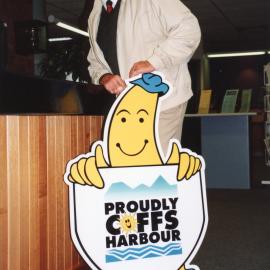 Councillor John Essex-Clark with the "Proudly Coffs Harbour" logo