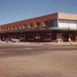 A silent cop stands alone after the parade has passed by, c.1960