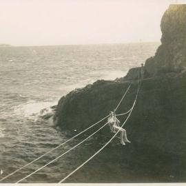Visitor Gordon Bailey crosses to Bird Island on a flying fox, 1946