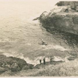 Lightkeeper Tom McKinnon crosses to Bird Island with flying fox cables, 1946