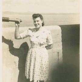 Beryl Duncan with telescope on South Solitary Island, 1946