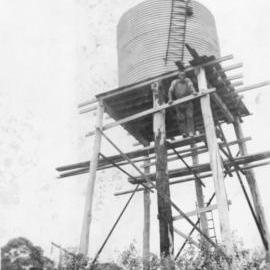 Chris Lewthwaite checking the water level in a tank off Englands Road, 1950