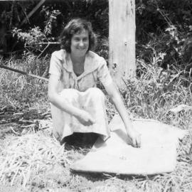 Noelene Lewthwaite lays out morning tea near the pumpkin patch off Englands Road, 1950