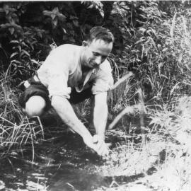 Chris Lewthwaite washing his hands in the creek, 1950
