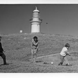 Pat Ross playing cricket with John and Mick Ross at South Solitary Island, early 1970s