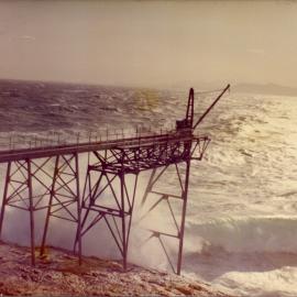 Waves crash against the gantry at South Solitary Island, early 1970s