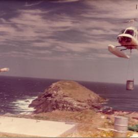 A helicopter delivers supplies to North Solitary Island, mid 1970s