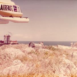 An Airfast helicopter delivers supplies to North Solitary Island, mid 1970s