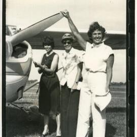 Aviators Judy Riddel and Jean Livesey with Liz Black holding the prop