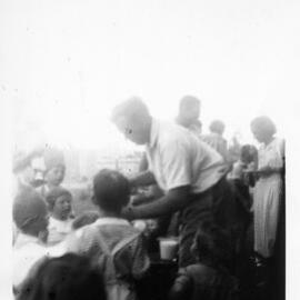Serving ice-cream at the Raleigh butter factory Christmas party, c.1950