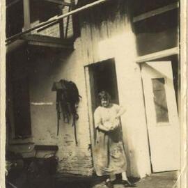 Woman outside a butchery, Karangi