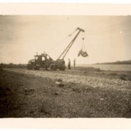 Photograph of two men on a tractor