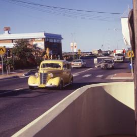 Classic car driving along Jetty Strip