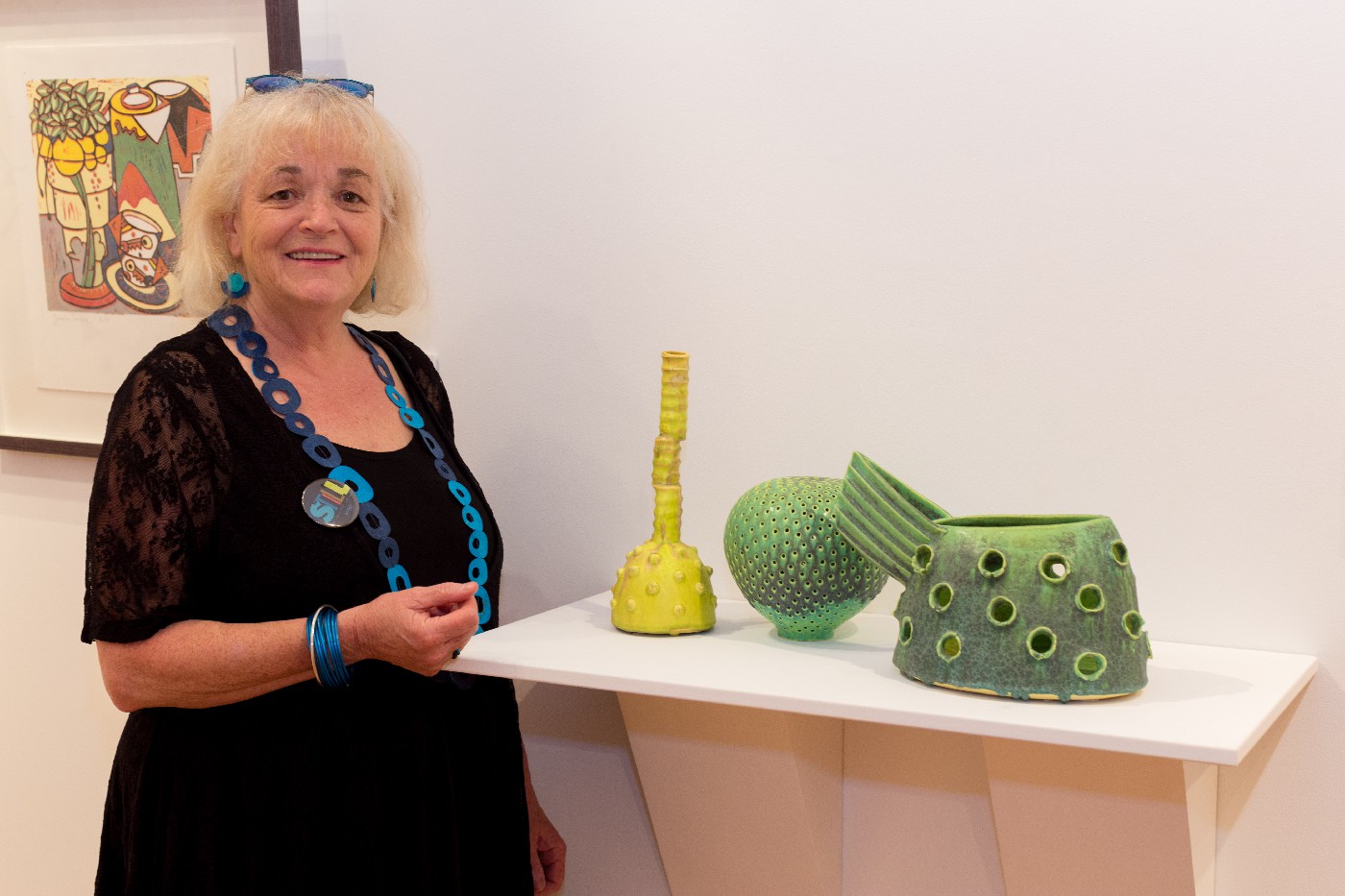 Merran Esson with her work "Green Still Life with Yellow Bottle" at the opening of Still: National Still Life Award 2017.Merran Esson with her work "Green Still Life with Yellow Bottle" at the opening of Still: National Still Life Award 2017.Merran Esson with her work "Green Still Life with Yellow Bottle" at the opening of Still: National Still Life Award 2017.